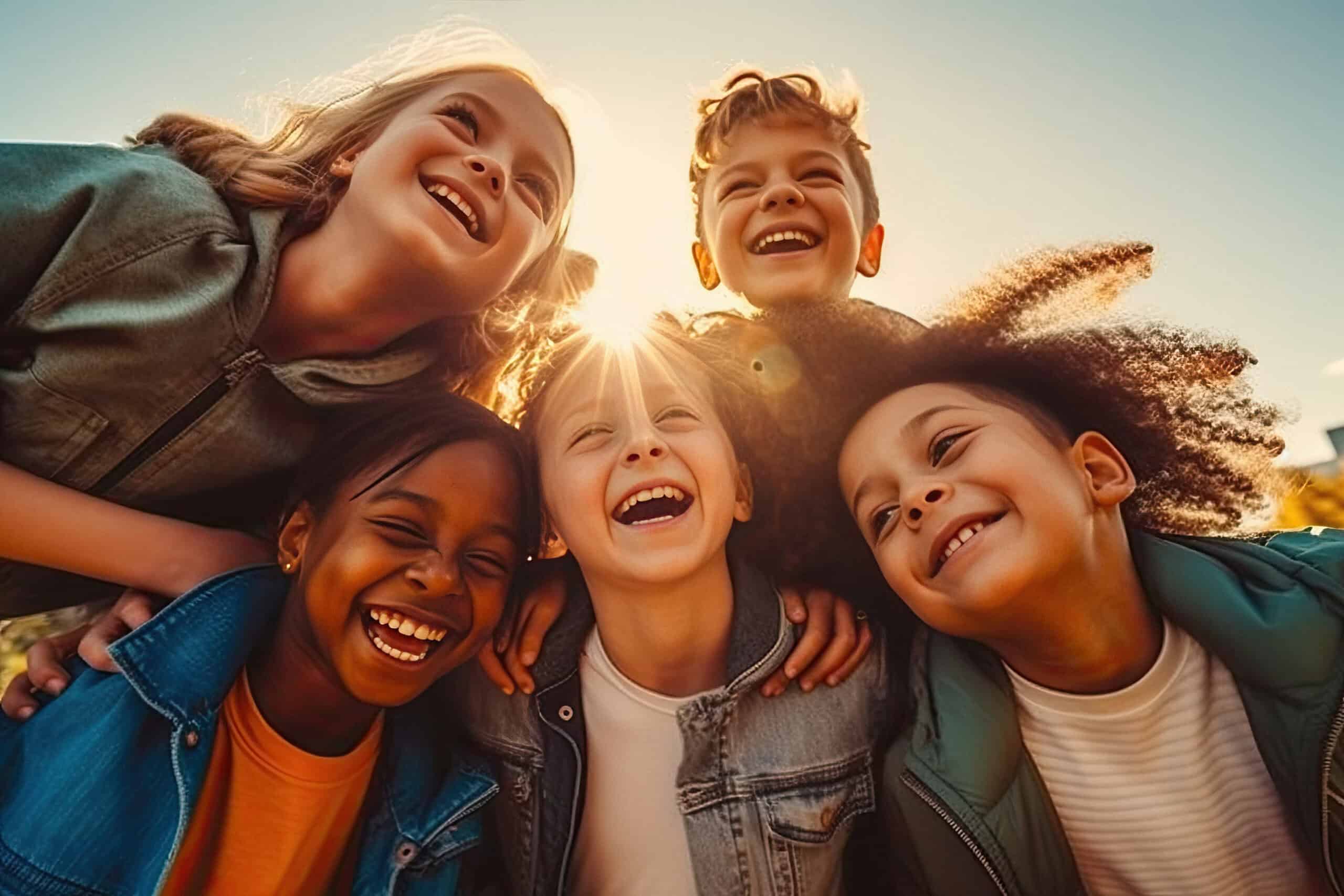 Smiling diverse children joyfully outdoors at sunset, representing El Dorado Adventist School community.