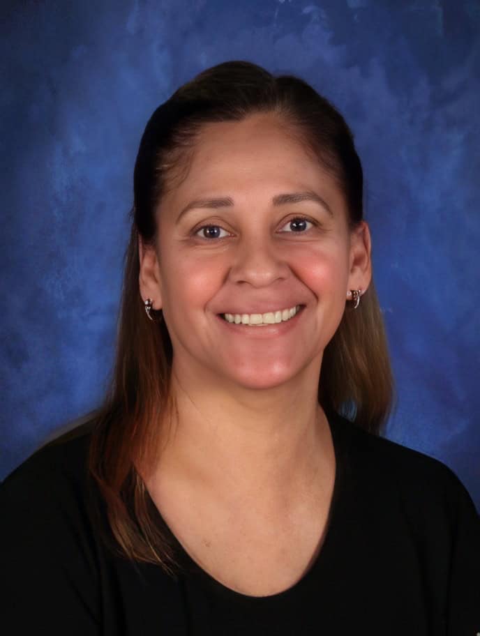 Kindergarten teacher portrait at El Dorado Adventist School, smiling in classroom setting.