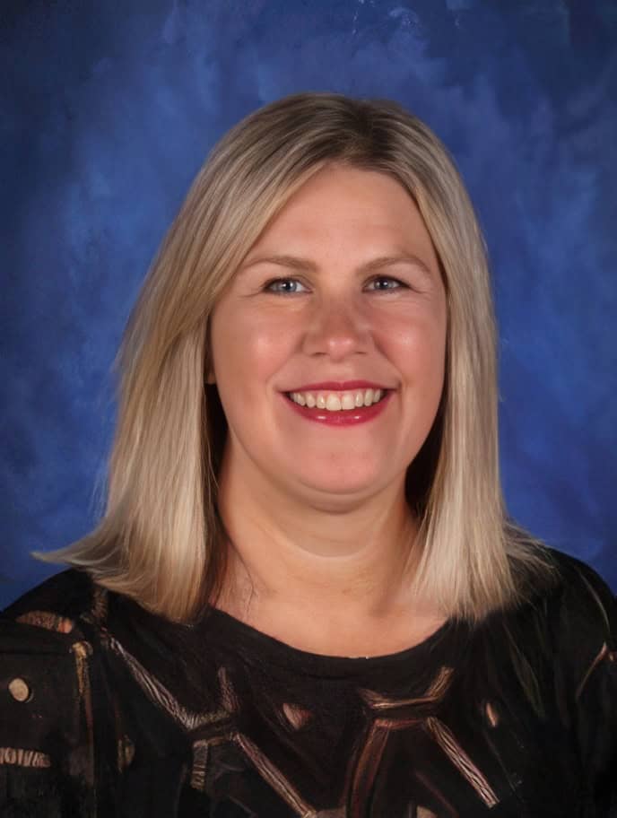 Bright smiling woman in professional portrait for El Dorado Adventist School promotional image.