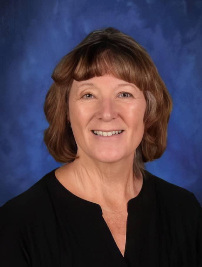 Friendly woman smiling, El Dorado Adventist School staff portrait, warm educational environment, professional staff, school community.