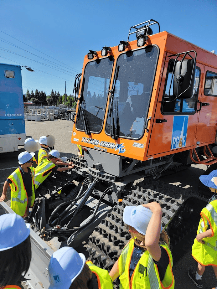 Excavator for educational field trip, El Dorado Adventist School students learning construction machinery.