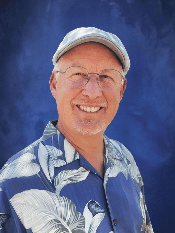 Friendly smiling man in Hawaiian shirt and cap at El Dorado Adventist School, promoting education and community engagement.