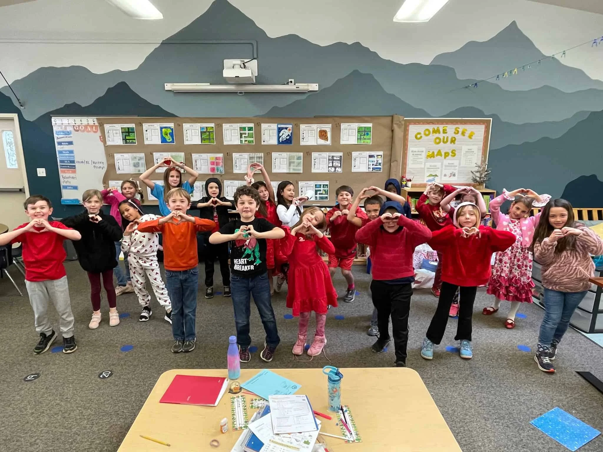 Kindergarten students making heart shapes in the classroom at El Dorado Adventist School.