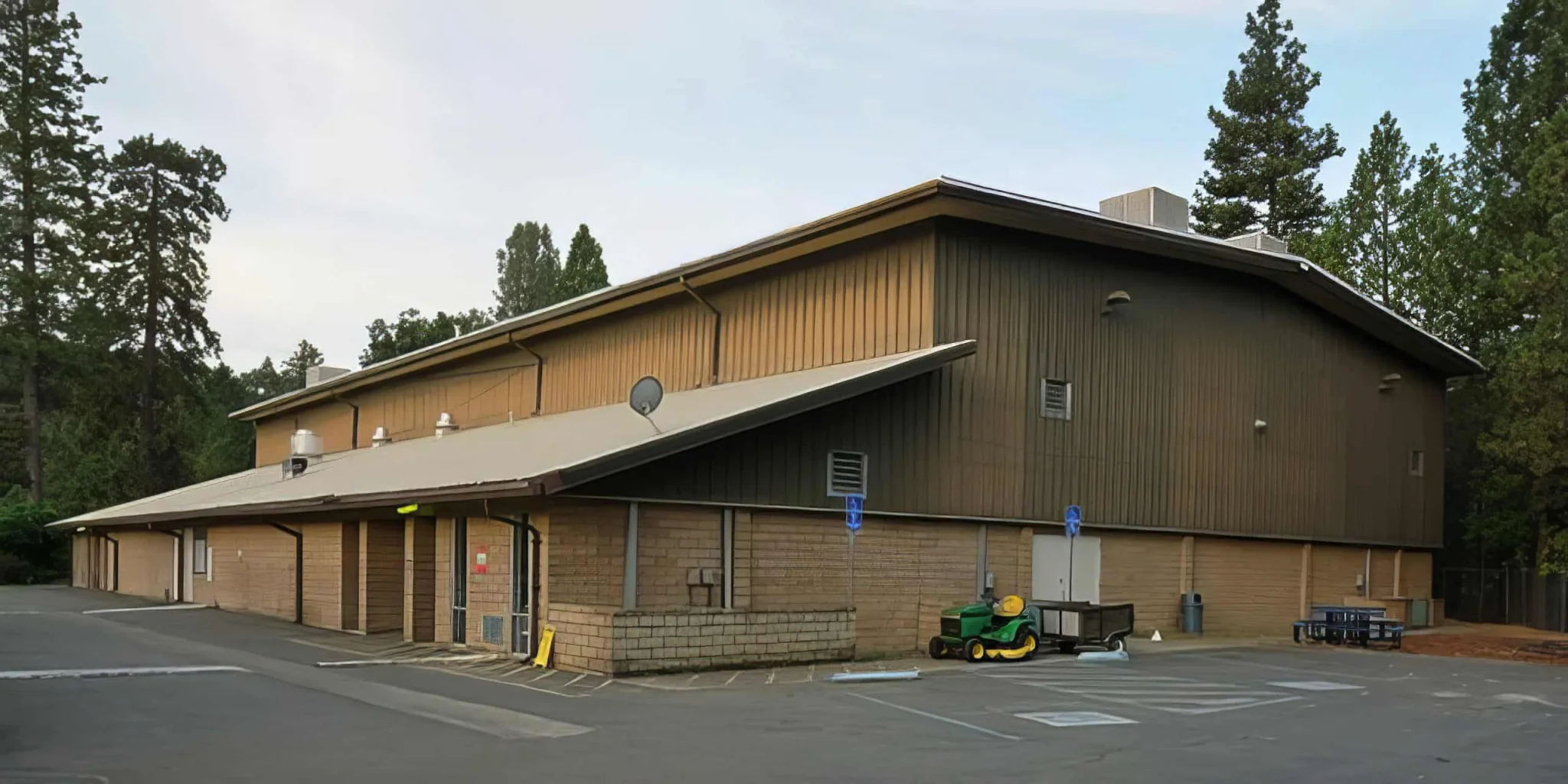 Modern El Dorado Adventist School building with parking lot and surrounding trees.