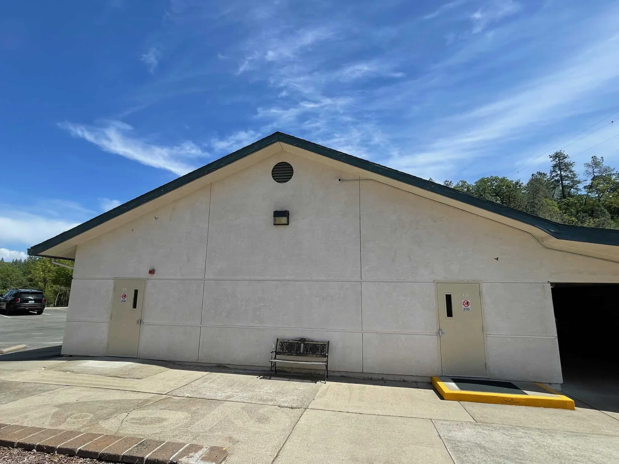 Modern building exterior of El Dorado Adventist School under a bright blue sky.
